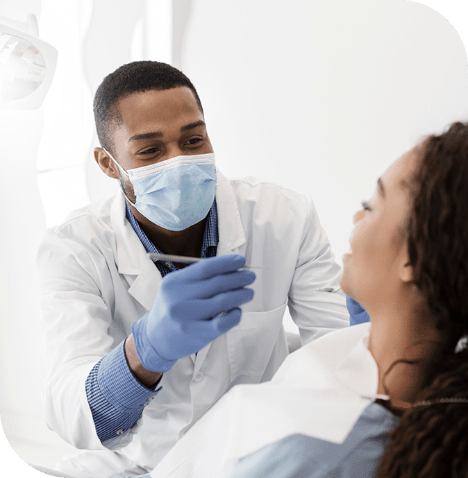 A dental hygienist checks in with a patient